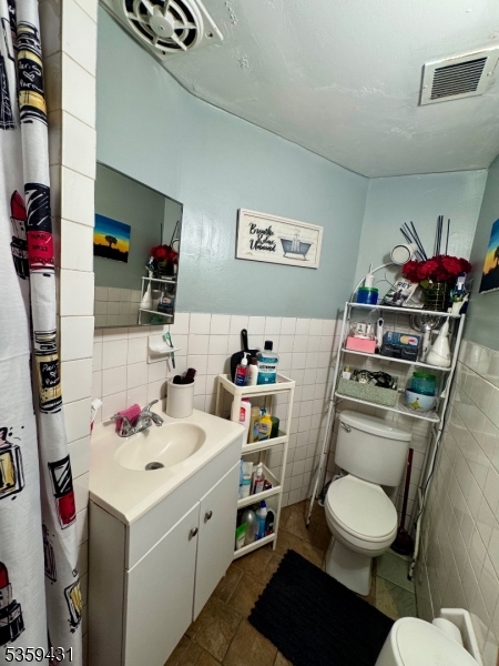 57 East Main Street Paterson, NJ 07522 - Photo 13 of 20 a bathroom with a sink toilet and a shower