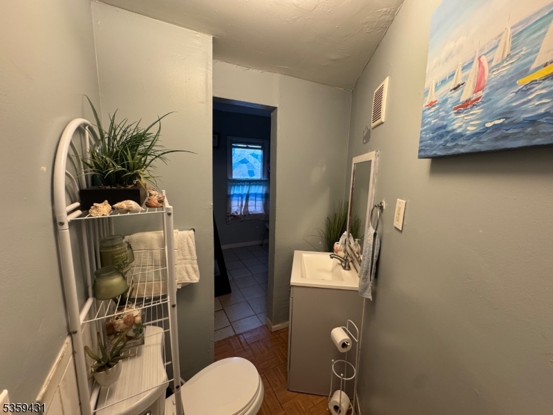 57 East Main Street Paterson, NJ 07522 - Photo 15 of 20 a bathroom with a toilet and a mirror