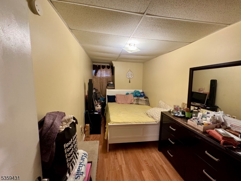 57 East Main Street Paterson, NJ 07522 - Photo 16 of 20 a room with a bed and a mirror