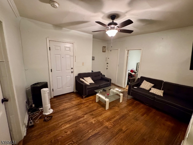 57 East Main Street Paterson, NJ 07522 - Photo 19 of 20 a living room with furniture and a chandelier