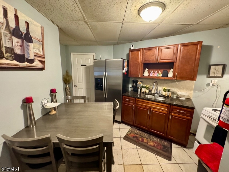 57 East Main Street Paterson, NJ 07522 - Photo 9 of 20 a kitchen with stainless steel appliances granite countertop a sink and a refrigerator