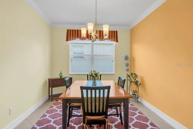 a view of a dining room with furniture and chandelier