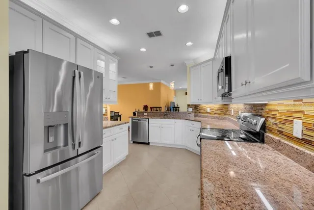 a kitchen with stainless steel appliances a refrigerator sink and stove