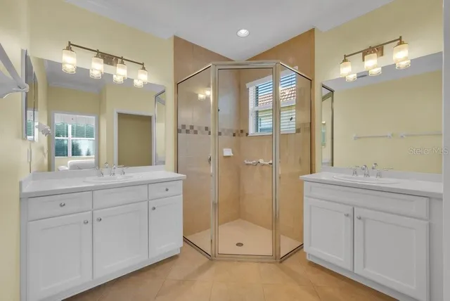 a bathroom with a double vanity sink mirror and double