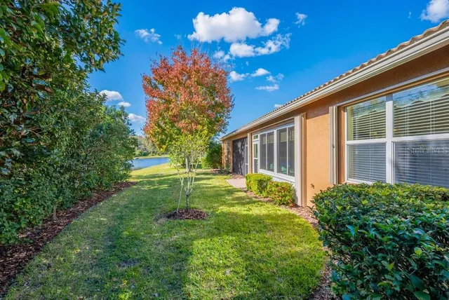 a view of a house with backyard and sitting area