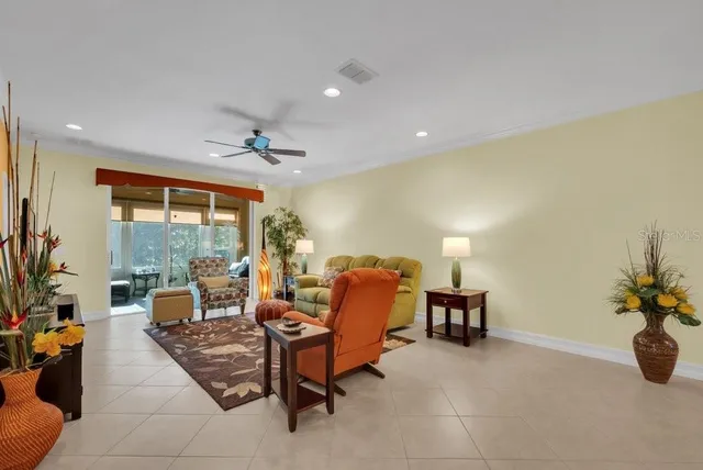 a living room with furniture and a potted plant