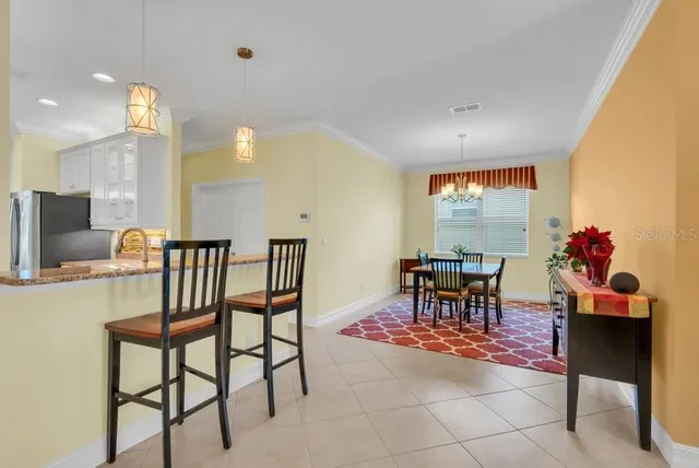 a view of a dining room with furniture and a potted plant