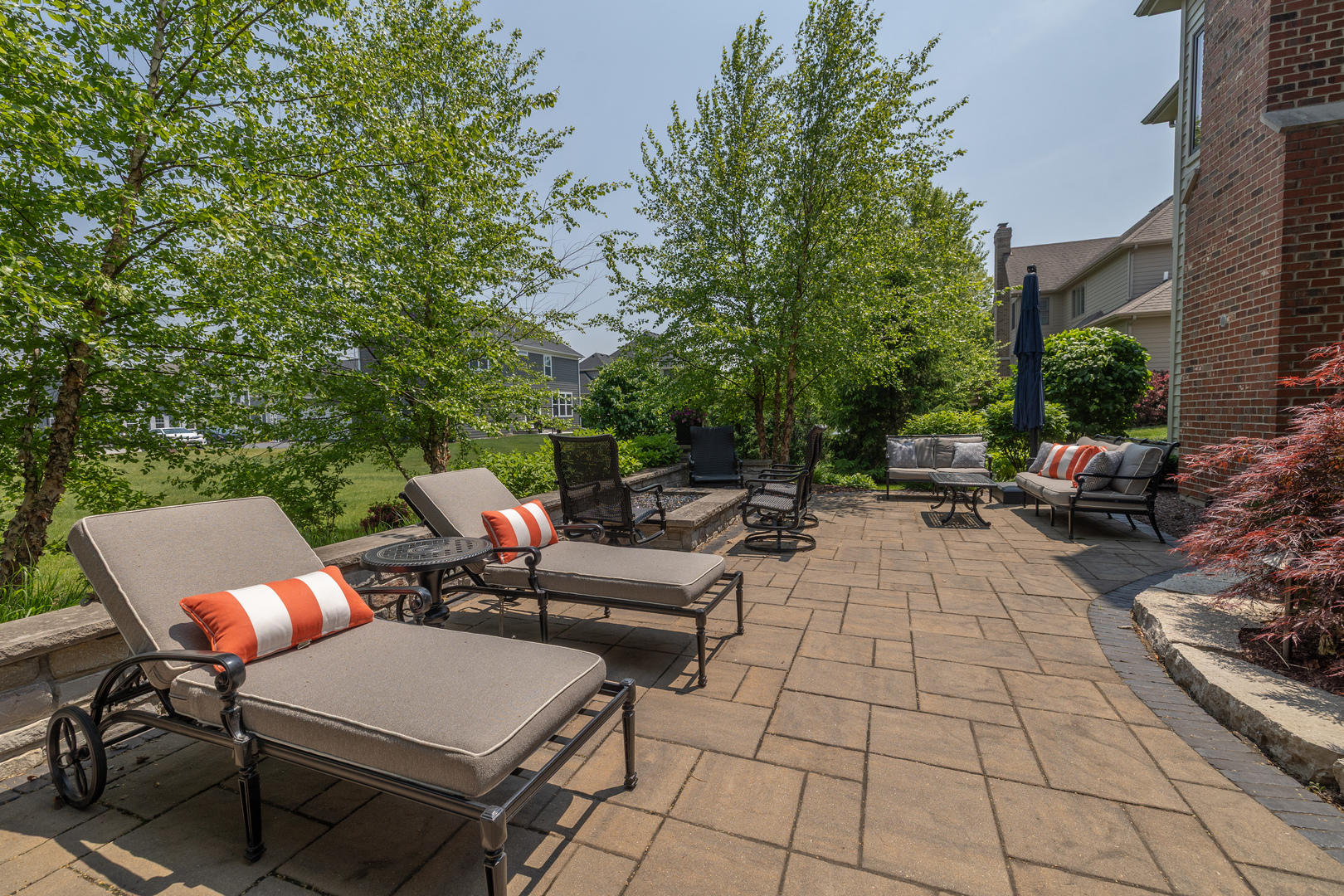 3680 Broadleaf Avenue Elgin, IL 60124 - Photo 55 of 69 a view of a patio with dining table and chairs with a small yard and plants