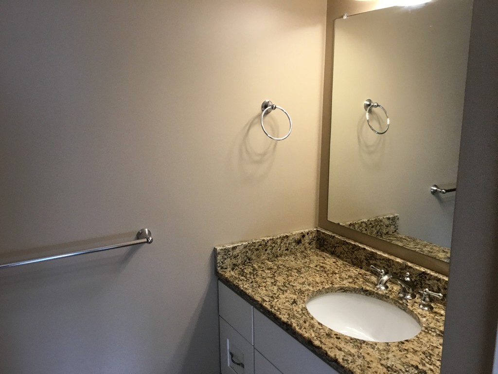 85 B Maple Avenue, Unit B Rutland, MA 01543 - Photo 9 of 19 a bathroom with a granite countertop sink a mirror and a shower