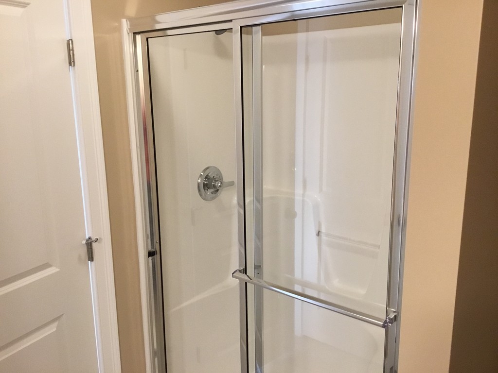 85 B Maple Avenue, Unit B Rutland, MA 01543 - Photo 10 of 19 a bathroom with a glass shower door