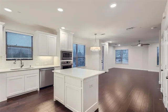 a view of a room with wooden floor and chandelier