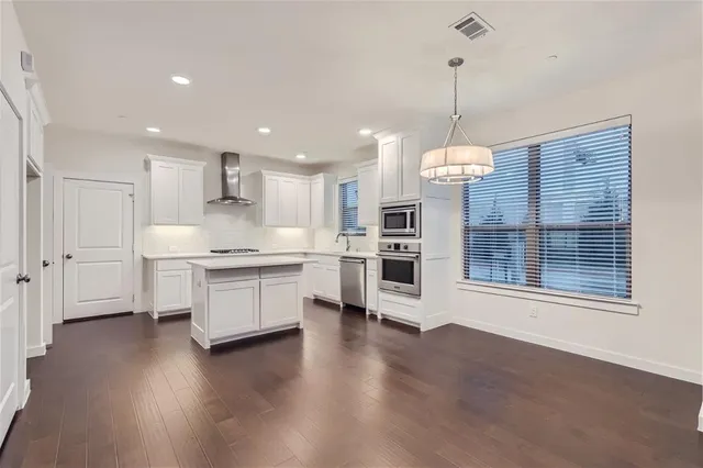 a kitchen with a sink and a stove top oven