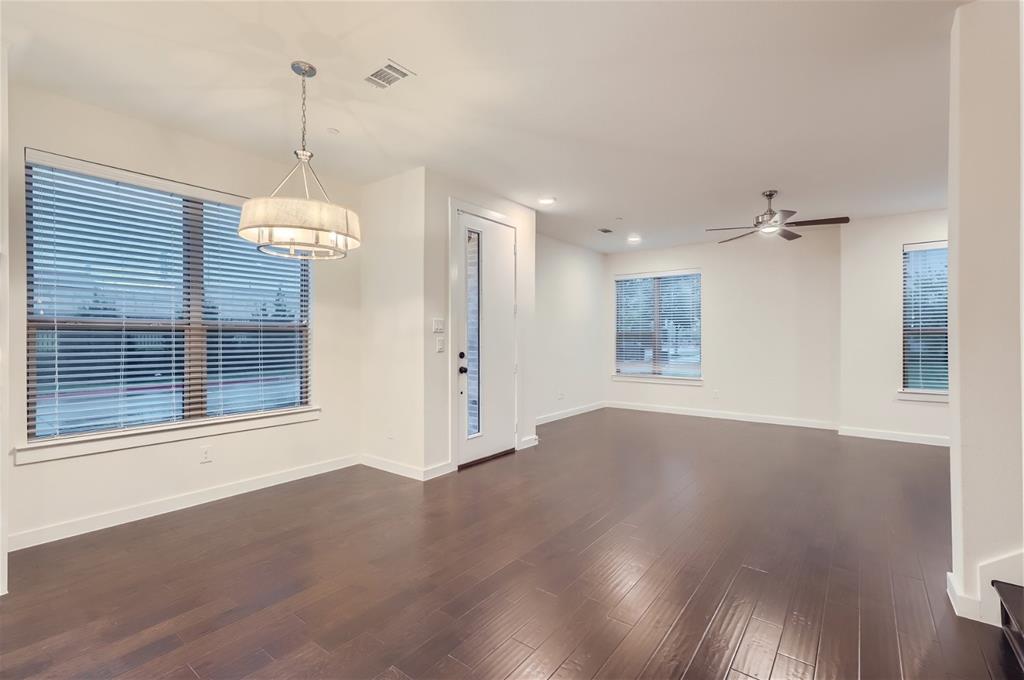 401 Division Street Plano, TX 75075 - Photo 13 of 28 a view of an empty room with wooden floor and a window