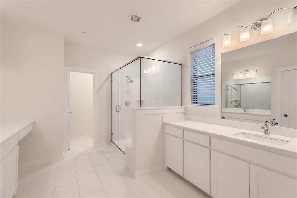 401 Division Street Plano, TX 75075 - Photo 18 of 28 a bathroom with a double vanity sink and mirror