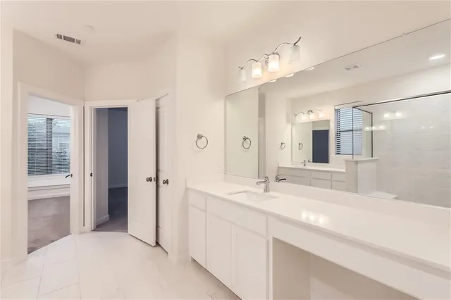 a bathroom with a double vanity sink and mirror