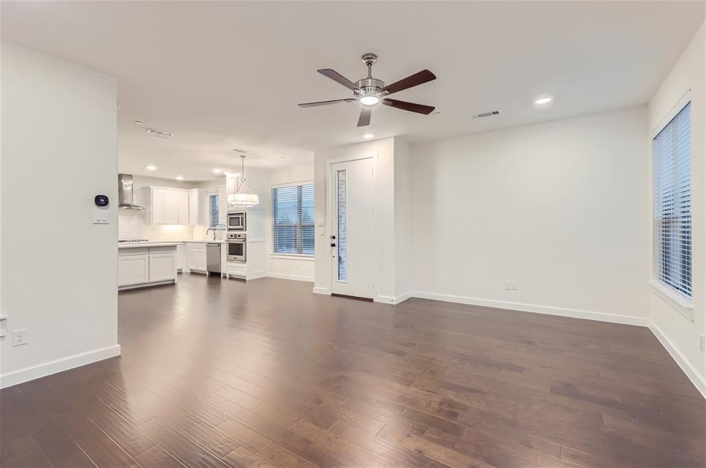 401 Division Street Plano, TX 75075 - Photo 6 of 28 a view of an empty room with a window and wooden floor