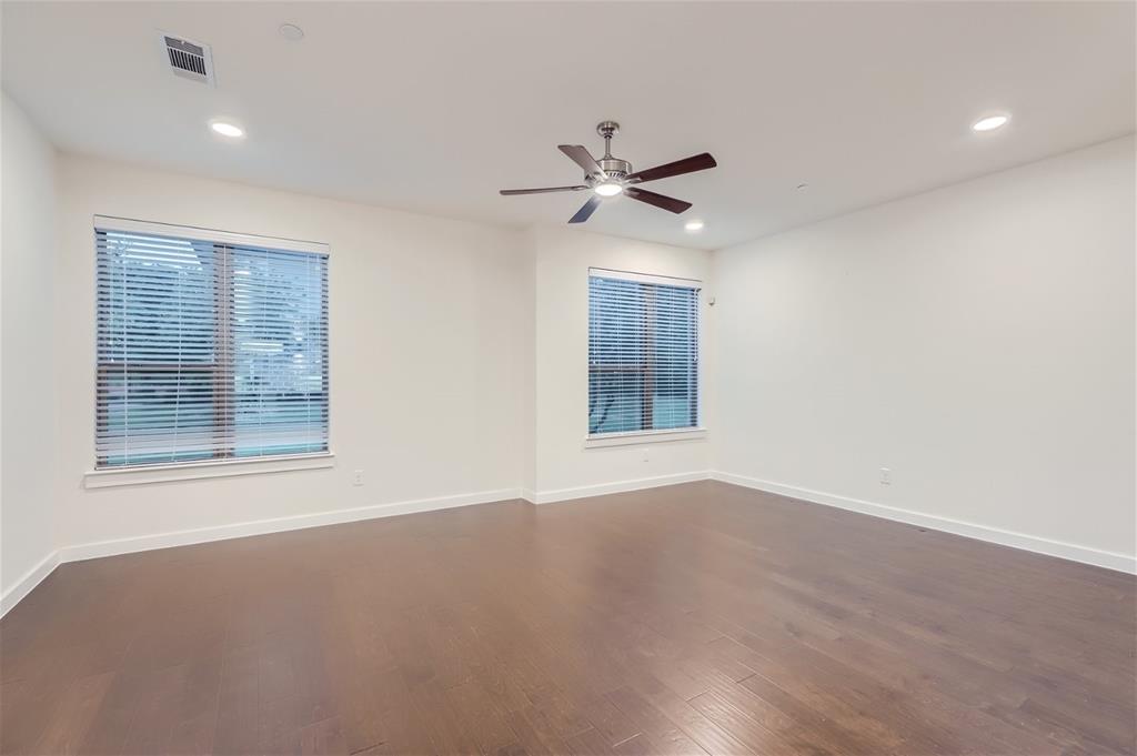 401 Division Street Plano, TX 75075 - Photo 8 of 28 a view of an empty room with a window and wooden floor