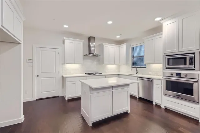 a kitchen with a stove oven and sink