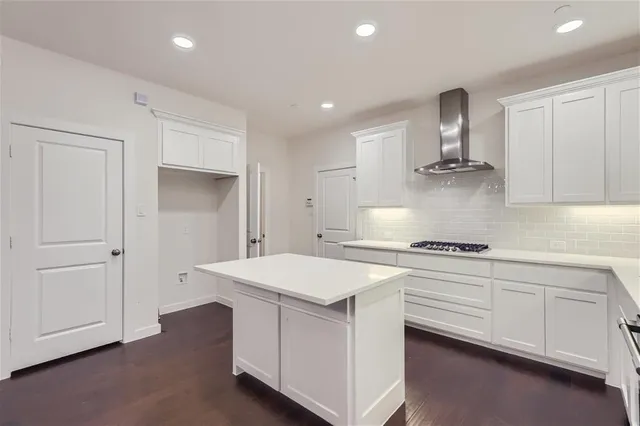a kitchen with a stove a sink and a refrigerator