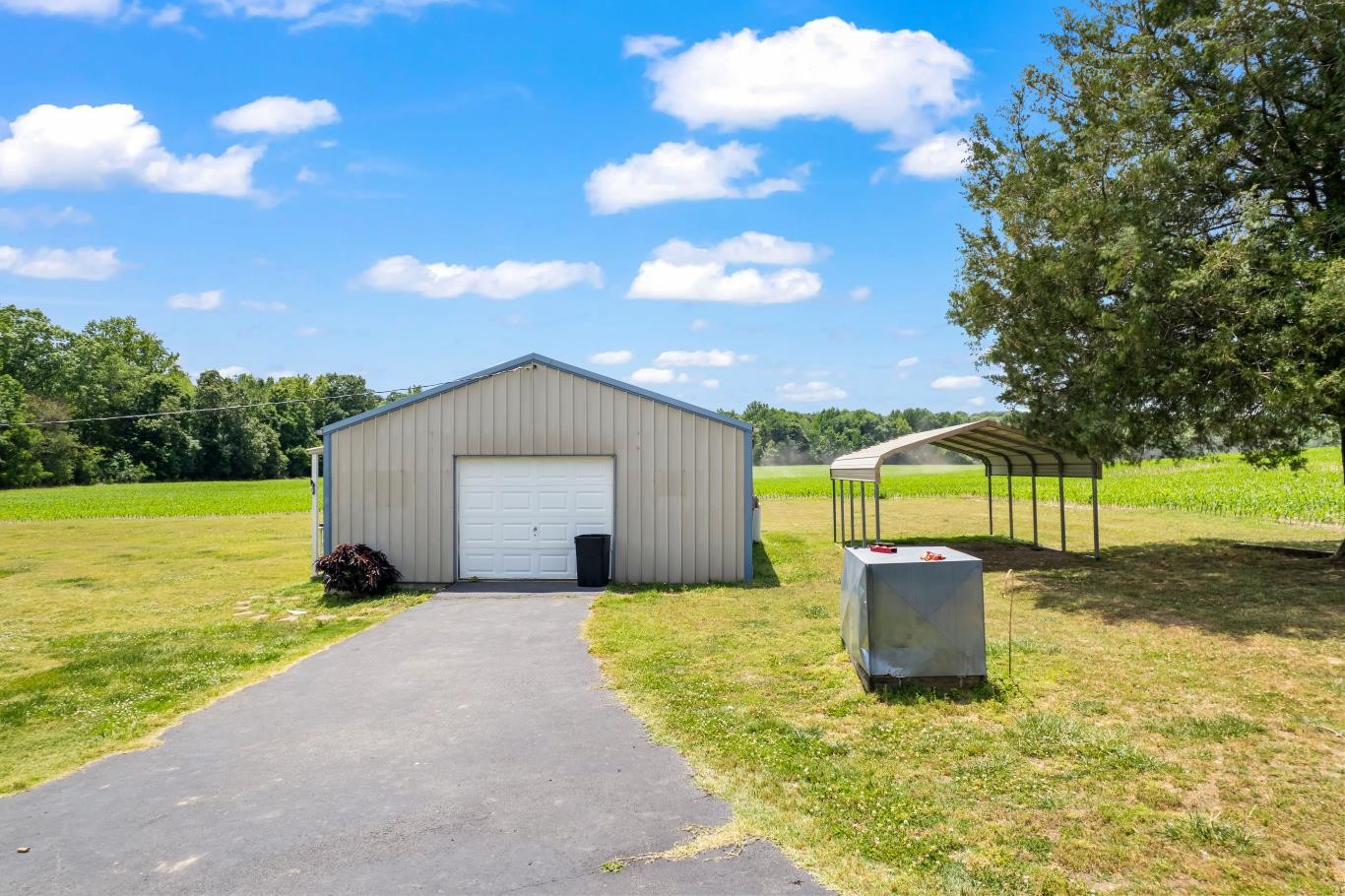 6439 Cedar Grove Road Big Sandy, TN 38221 - Photo 2 of 38 a backyard of a house with table and chairs