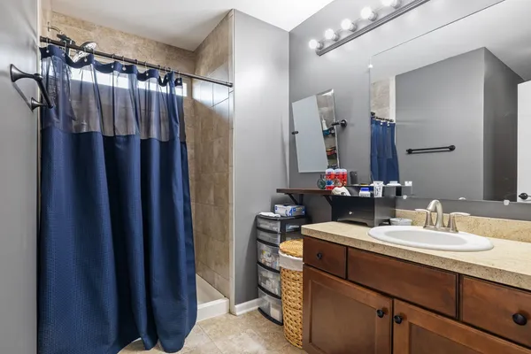 a view of walk in closet with clothes