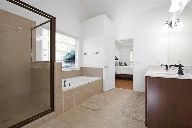 a spacious bathroom with a bathtub sink and mirror
