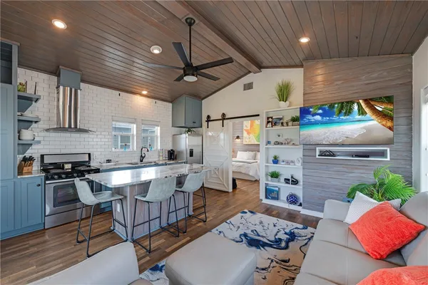 a kitchen with a table chairs stove and cabinets