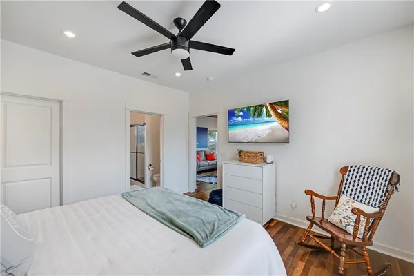 a bedroom with a bed and a dresser