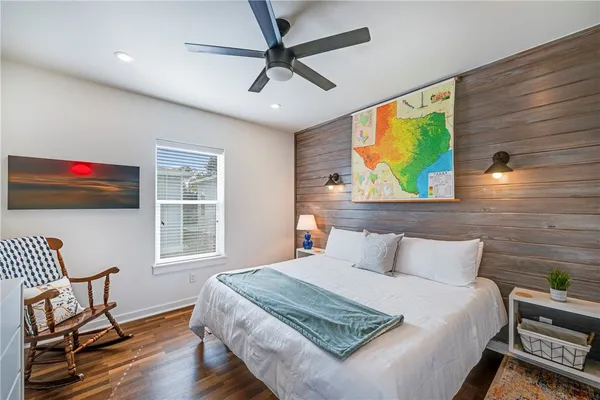 a bedroom with a bed and a chair