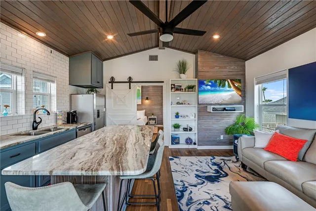 a living room with furniture and kitchen view