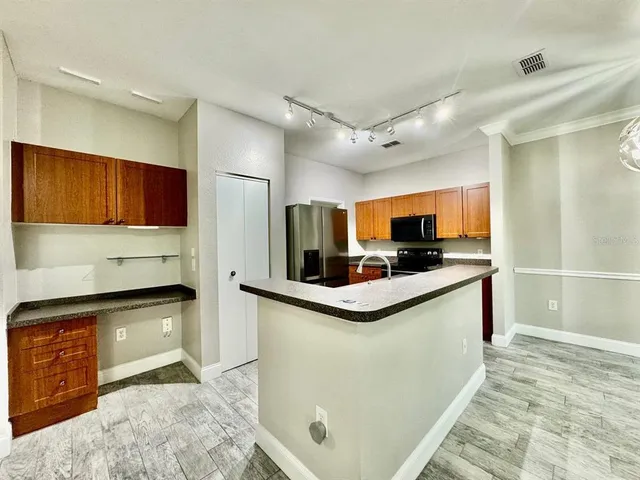 a kitchen with stainless steel appliances granite countertop a sink and a stove