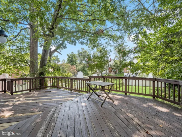 a view of balcony with wooden floor and fence