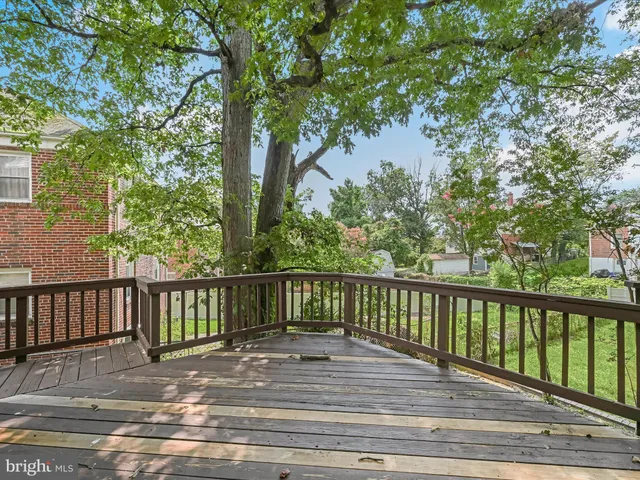 a balcony with wooden floor and fence