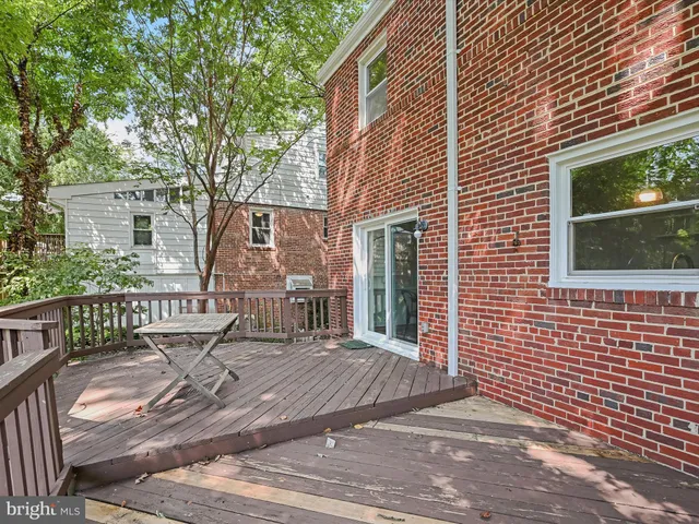 a view of a house with a bench in wooden floor