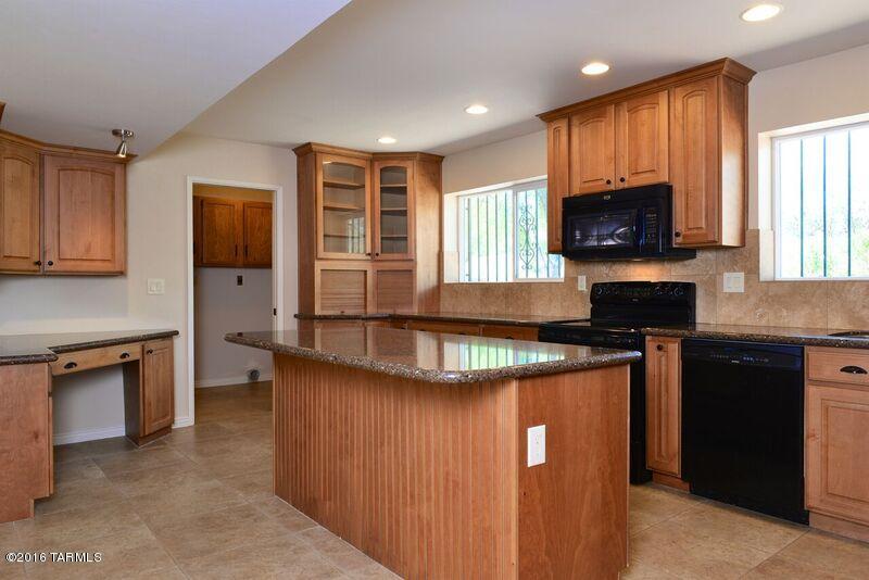 8001 East Presidio Road Tucson, AZ 85750 - Photo 6 of 25 a kitchen with stainless steel appliances granite countertop a stove top oven a sink dishwasher and a microwave oven on the blue kitchen countertops