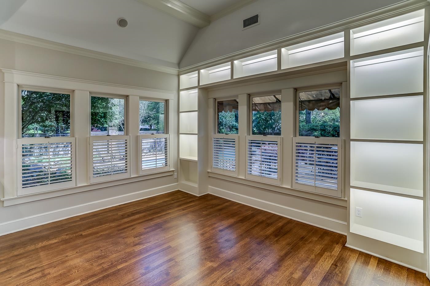 8711 Windrush Memphis, TN 38125 - Photo 20 of 40 a view of an empty room with wooden floor and a window
