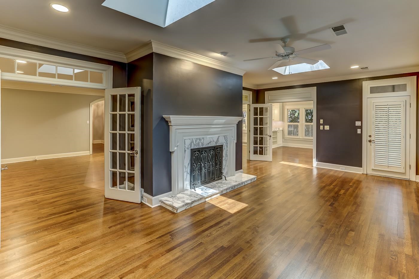 8711 Windrush Memphis, TN 38125 - Photo 23 of 40 a view of a livingroom with wooden floor a ceiling fan and window