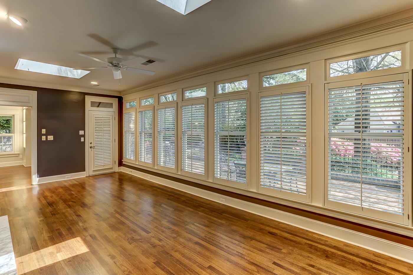 8711 Windrush Memphis, TN 38125 - Photo 24 of 40 a view of an empty room with wooden floor and a window