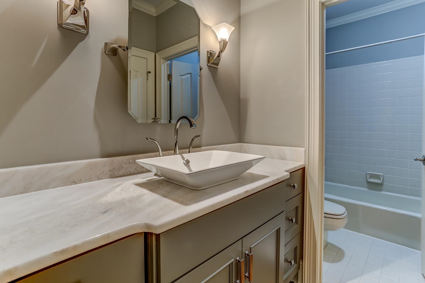 8711 Windrush Memphis, TN 38125 - Photo 28 of 40 a bathroom with a granite countertop sink and a mirror