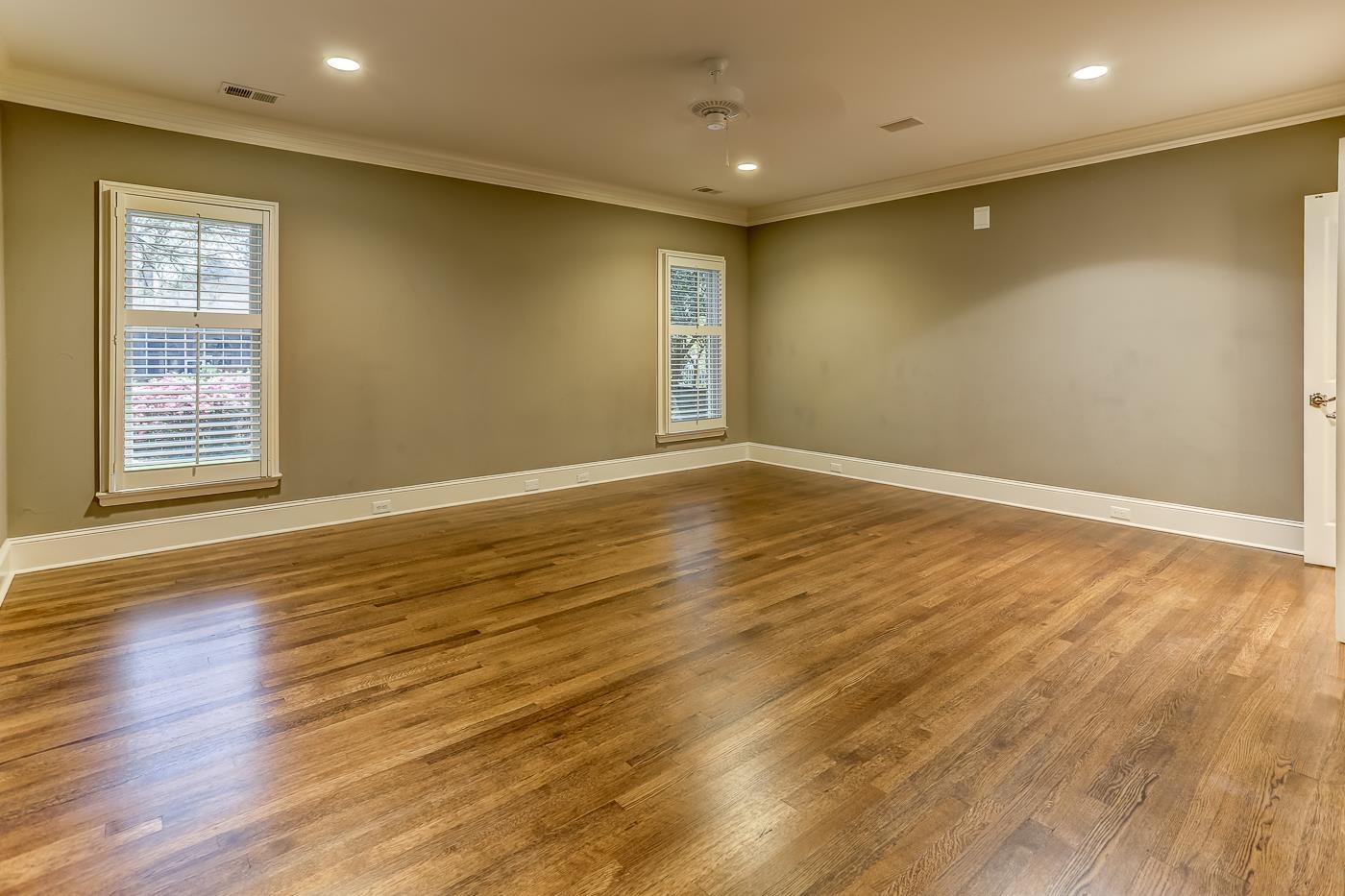 8711 Windrush Memphis, TN 38125 - Photo 29 of 40 a view of an empty room with wooden floor and a window