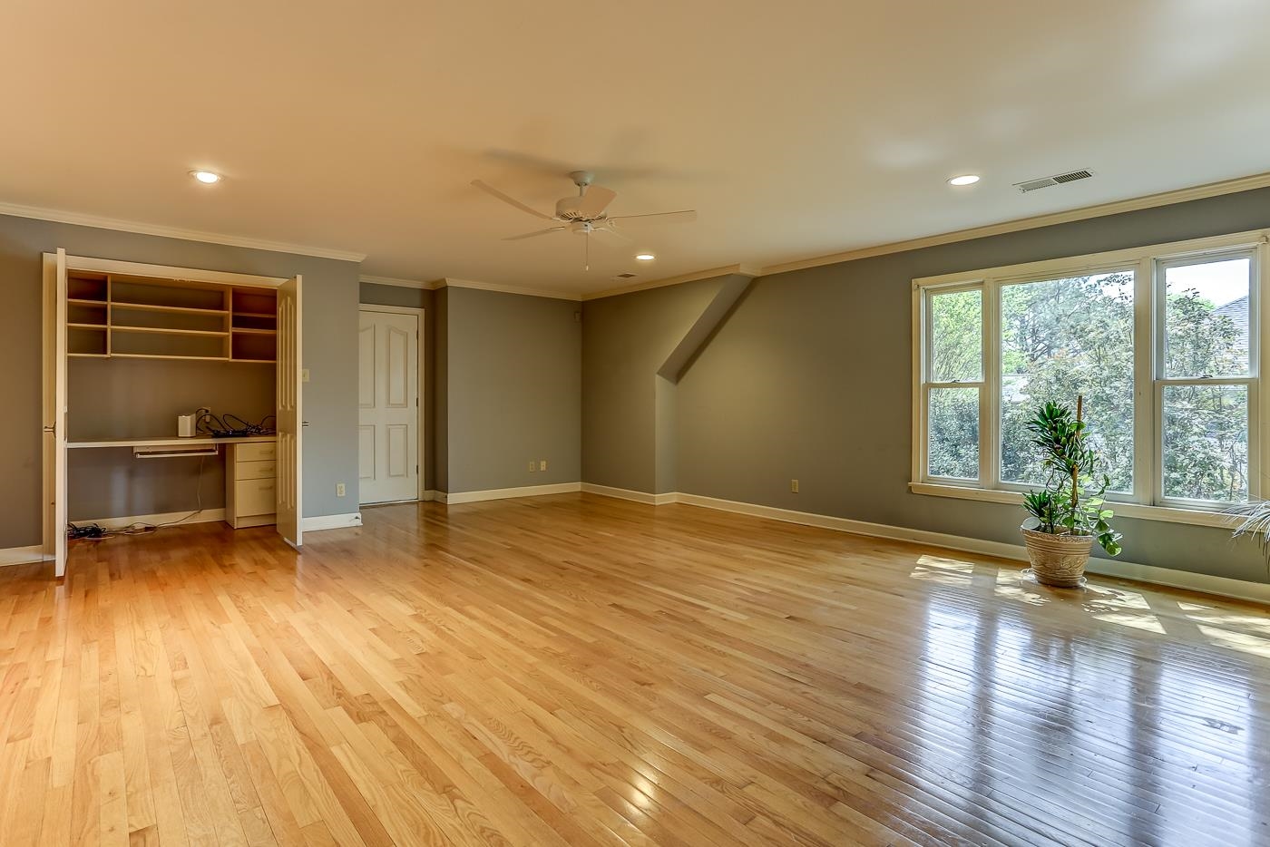 8711 Windrush Memphis, TN 38125 - Photo 38 of 40 a view of an empty room with a window and wooden floor
