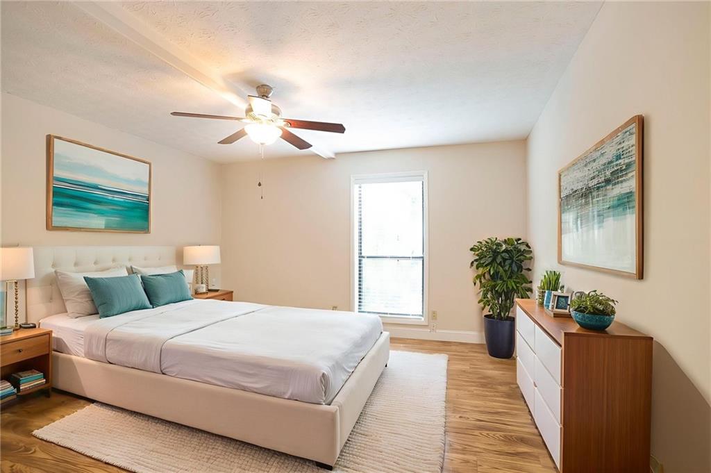 408 River Run Drive Sandy Springs, GA 30350 - Photo 15 of 34 a bedroom with a large bed chandelier and a window