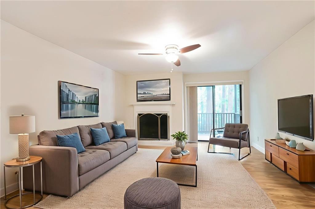 408 River Run Drive Sandy Springs, GA 30350 - Photo 3 of 34 a living room with furniture a fireplace and a flat screen tv