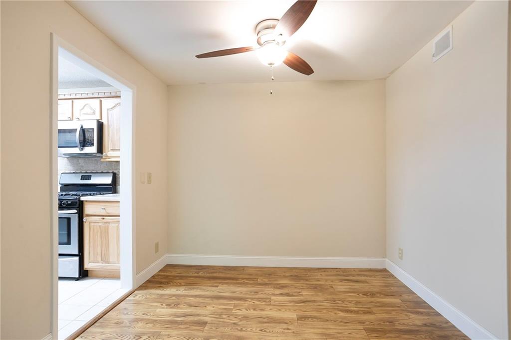408 River Run Drive Sandy Springs, GA 30350 - Photo 8 of 34 a view of kitchen and empty room with wooden floor