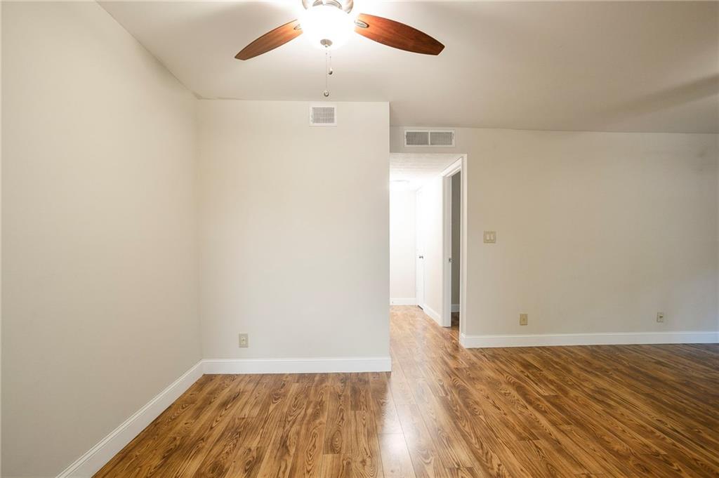 408 River Run Drive Sandy Springs, GA 30350 - Photo 10 of 34 an empty room with wooden floor and windows