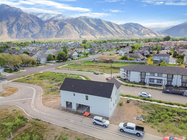 720 South Harrison Drive Springville, UT 84663 - Photo 9 of 14 Newly constructed two-story residence with a dark shingle roof and light-colored siding, featuring a two-car garage