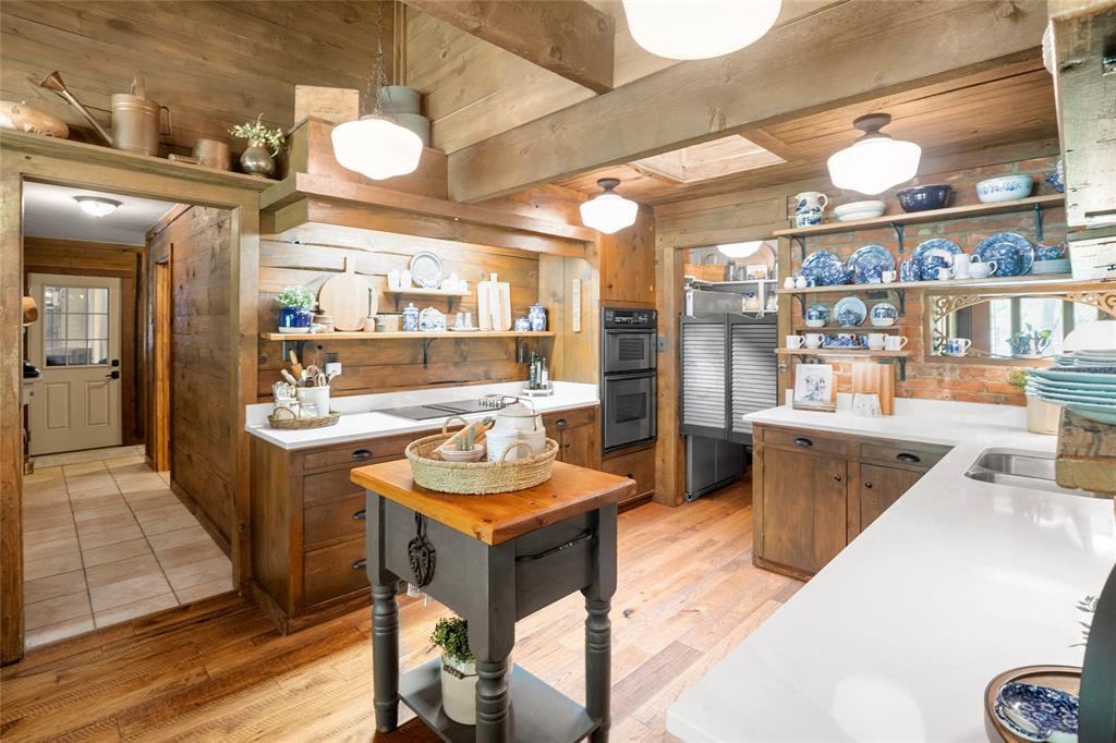 1516 Rancho Road Quinlan, TX 75474 - Photo 11 of 40 a dining hall with stainless steel appliances kitchen island granite countertop a sink and cabinets