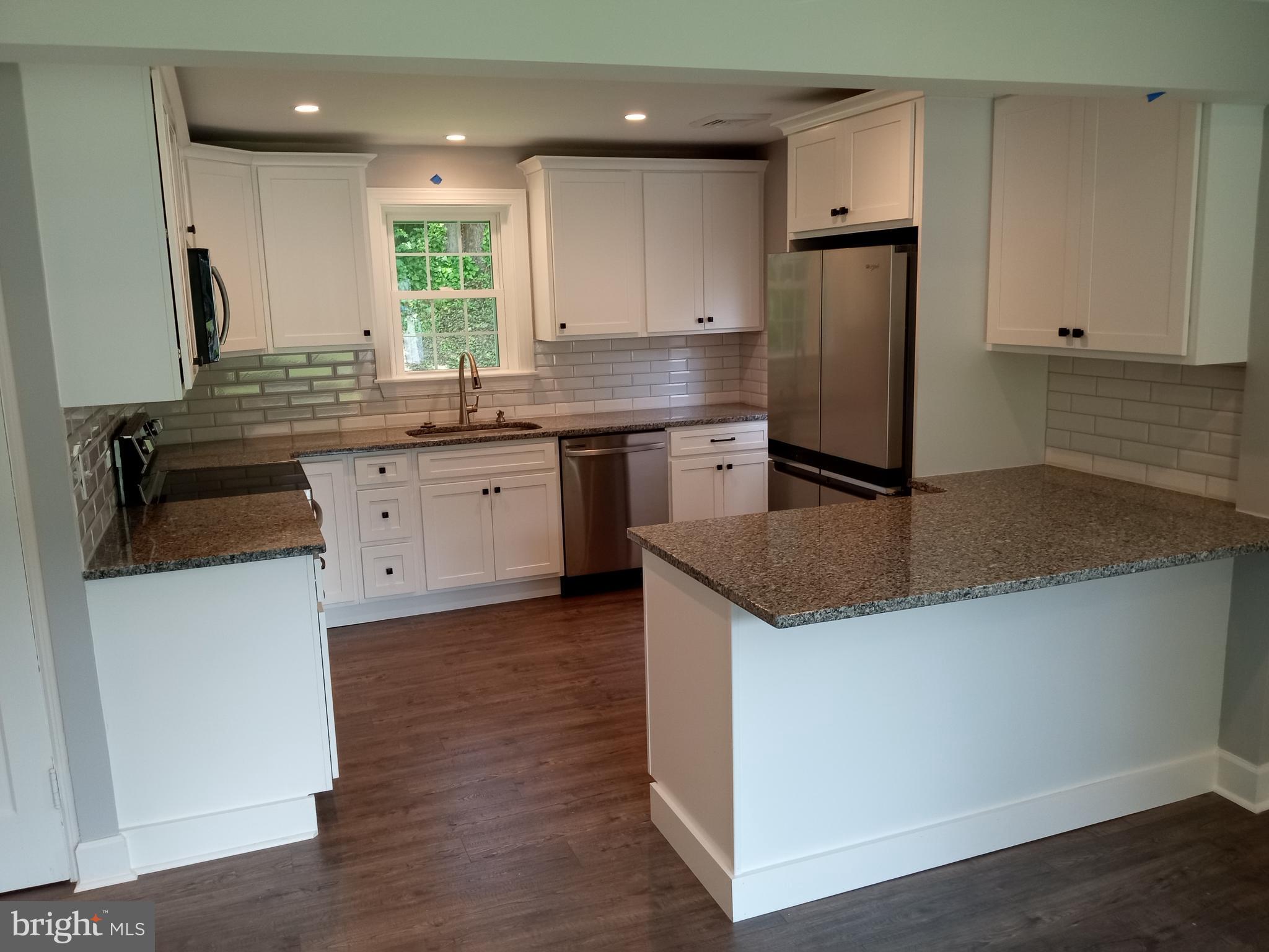 18 West Ridge Road Media, PA 19063 - Photo 2 of 7 a kitchen with kitchen island granite countertop a sink a counter space and stainless steel appliances