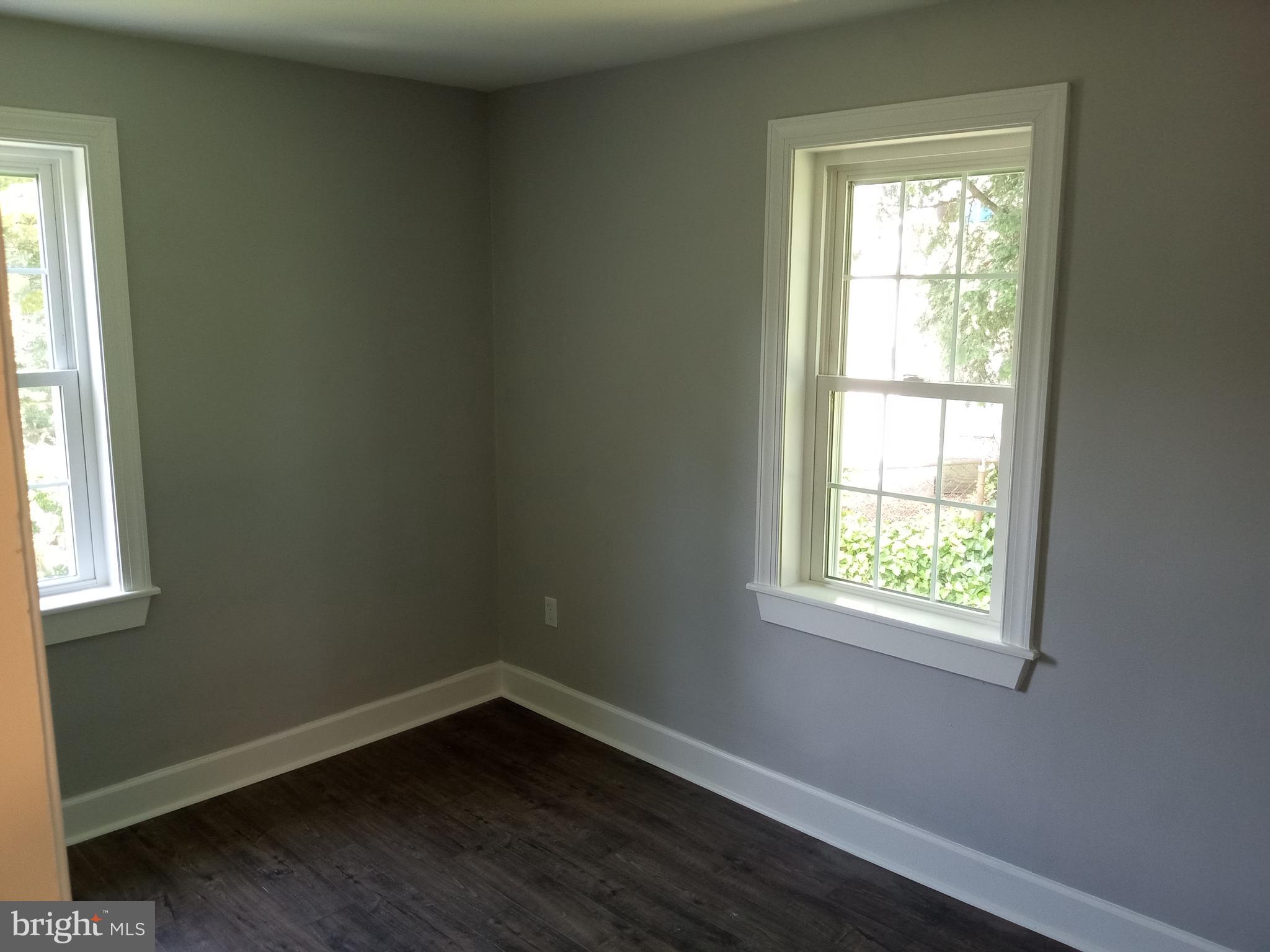18 West Ridge Road Media, PA 19063 - Photo 3 of 7 an empty room with wooden floor and windows