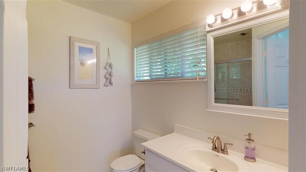 5186 Sea Bell Road Sanibel, FL 33957 - Photo 21 of 33 a bathroom with a sink vanity and toilet